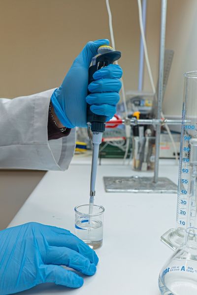 scientist sampling fluid in a laboratory